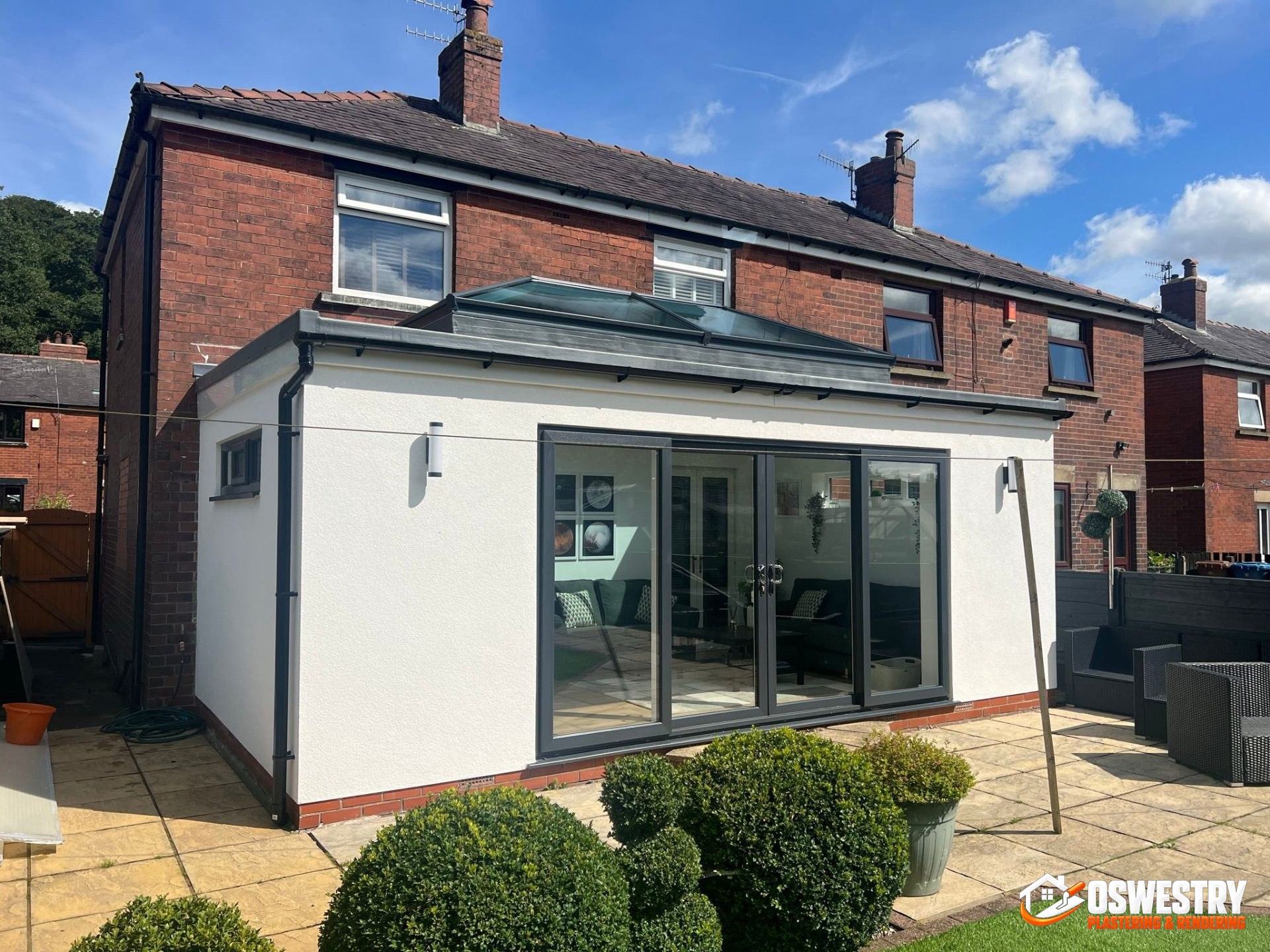 Modern UK rendered extension finished in K Rend silicone render combined with contrasting black timber cladding